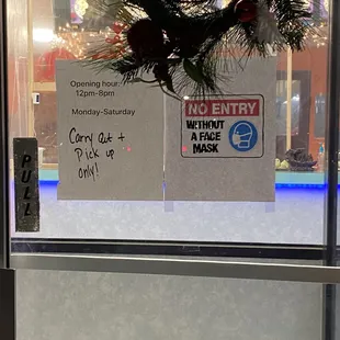 a christmas wreath hanging on a window