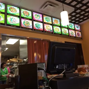 a restaurant's menu with multiple televisions