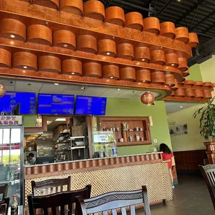 a restaurant with a large display of pots