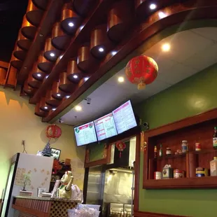 a restaurant counter with a large screen tv