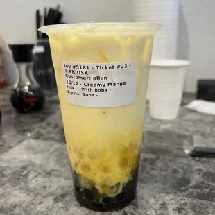 a plastic cup filled with yellow liquid