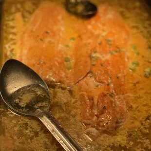 a fish dish with a spoon