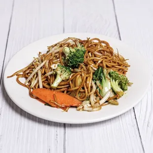 a plate of noodles with broccoli and carrots
