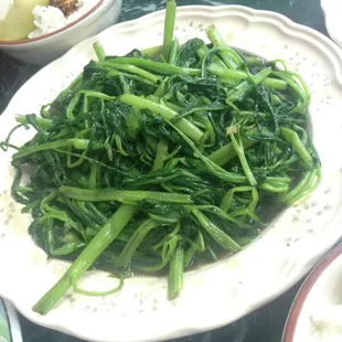 a plate of green vegetables on a table