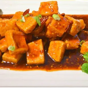 a plate of tofu and broccoli