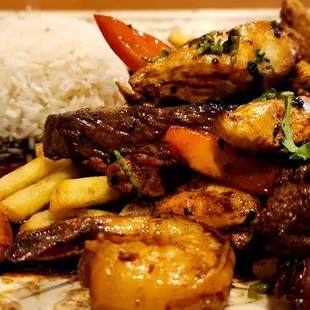 Tender chicken, flavorful steak, and amazing shrimp in a yummy sauce with French fries and rice.