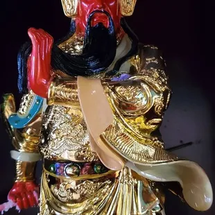 a statue of a man with a red ball in his hand