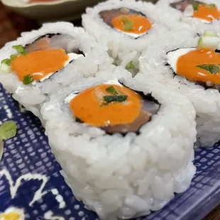 a plate of sushi rolls