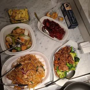 Takeout, bottom left counter-clockwise: chow mein, clay pot, spare ribs, broccoli beef