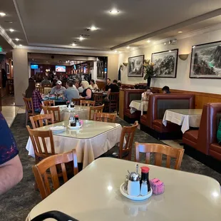 people sitting at tables and eating