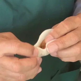 the hands of a woman in a green apron