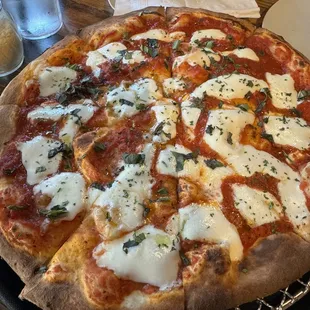 a pizza with cheese and basil