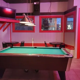a pool table in a brightly lit room