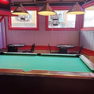 a pool table and chairs