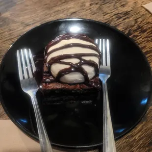 Dessert brownie,ice cream,chocolate syrup.