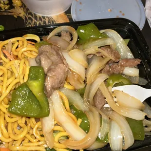a plate of noodles and beef