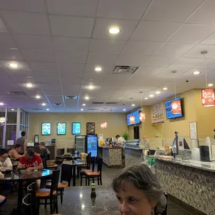 people sitting at tables in a restaurant