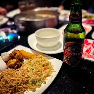 a plate of food and a bottle of beer