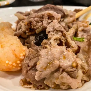 a plate of food with chopsticks