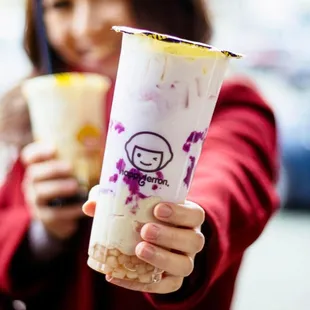 a woman holding a drink