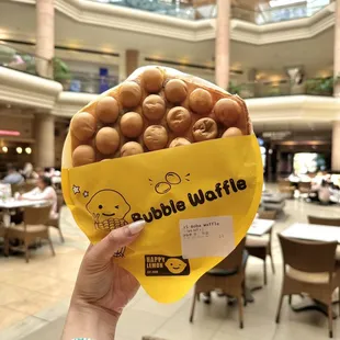 a person holding a bag of donuts