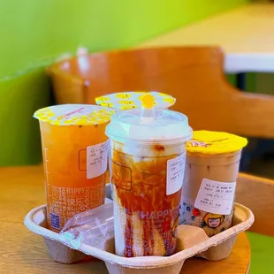 three cups of iced tea on a tray