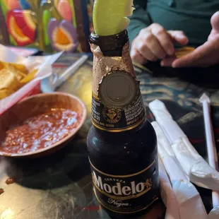a bottle of modelo with a lime wedge in it