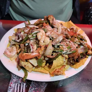 Steak, chicken, and shrimp nachos