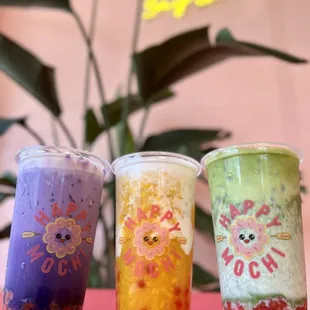 three different drinks in plastic cups