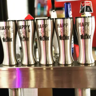 a row of beer glasses on a bar