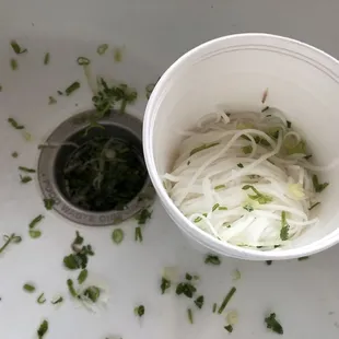 Pho noodles with cilantro and onions mixed. I asked for no cilantro because I&apos;m allergic to it.