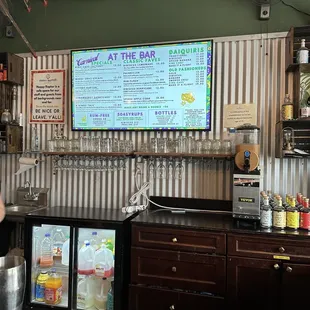 a bar with a menu on the wall