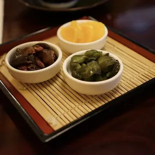 three bowls of pickles and an egg