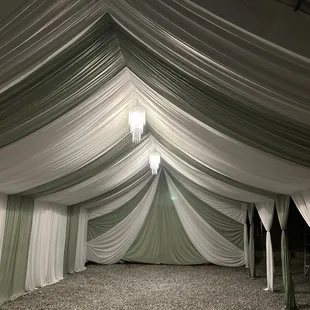 Tent with draping decor and chandeliers