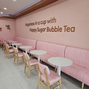 a row of pink seats and tables