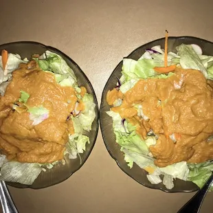 two plates of salad and a fork