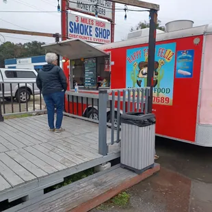 a woman walking towards a food truck