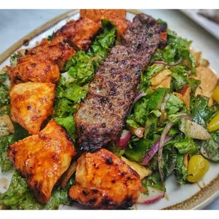 Beef kabab with chicken Tikka over fattoush salad