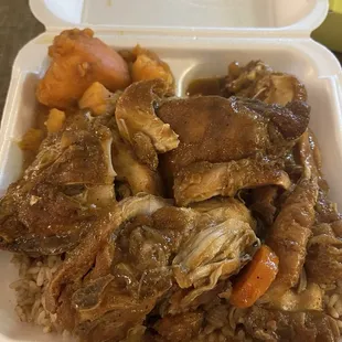 Large brown stew chicken, rice and peas, and sweet yams.