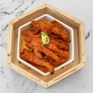 a bowl of chicken wings with avocado