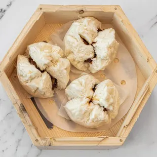 a wooden box of dumplings