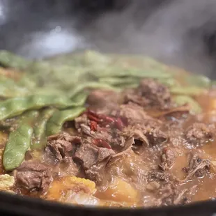 beef and vegetables cooking in a wok