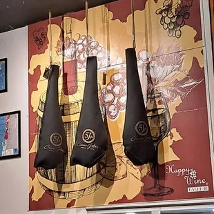 three hanging wine bottles