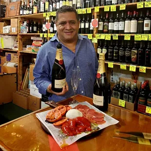 a man holding a bottle of wine