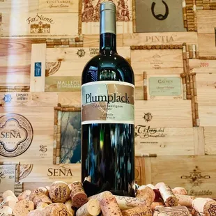 a bottle of wine surrounded by corks