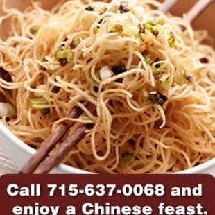 a bowl of noodles with chopsticks