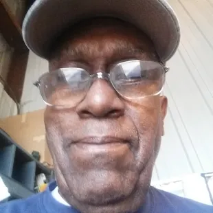 a man wearing glasses and a hat