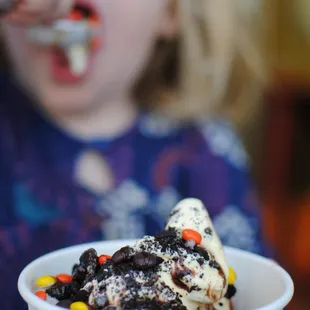 a child eating a bowl of ice cream