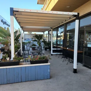 a patio with tables and chairs