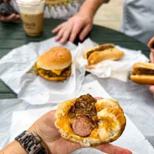 a person holding a hot dog in a bun